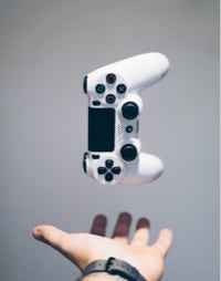 Image of a hand throwing up a gaming controller